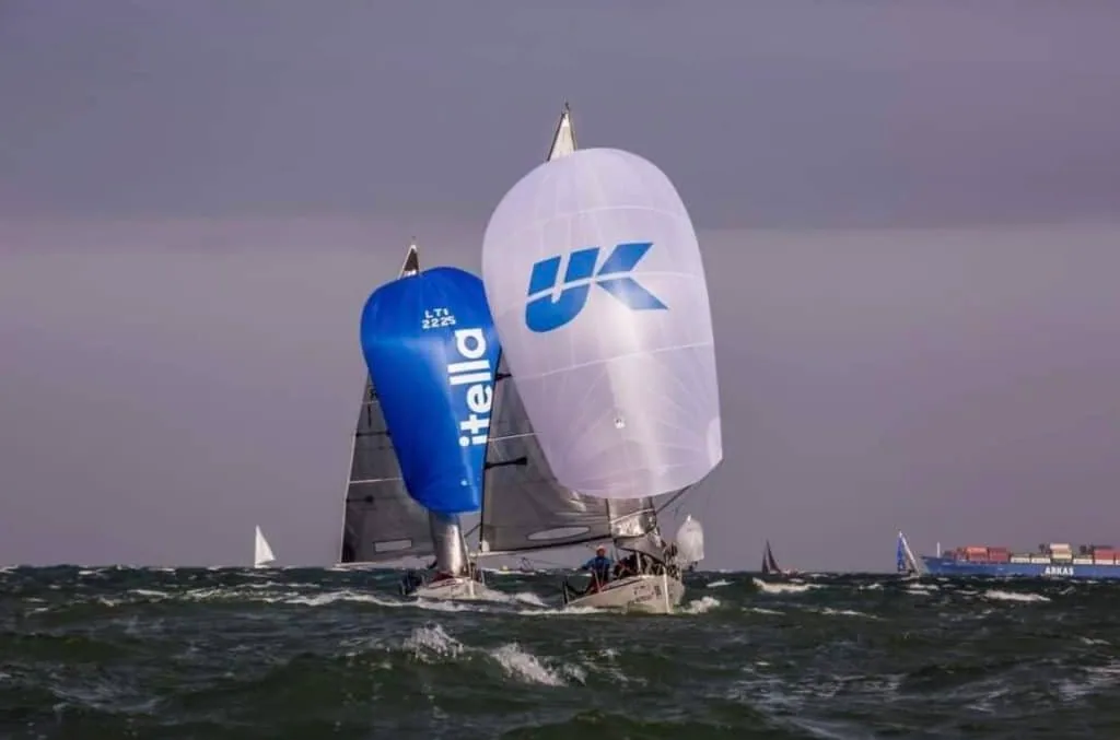 Two Platu 25s running downwind, one under a blue kite and one under a UK Sailmakers kite