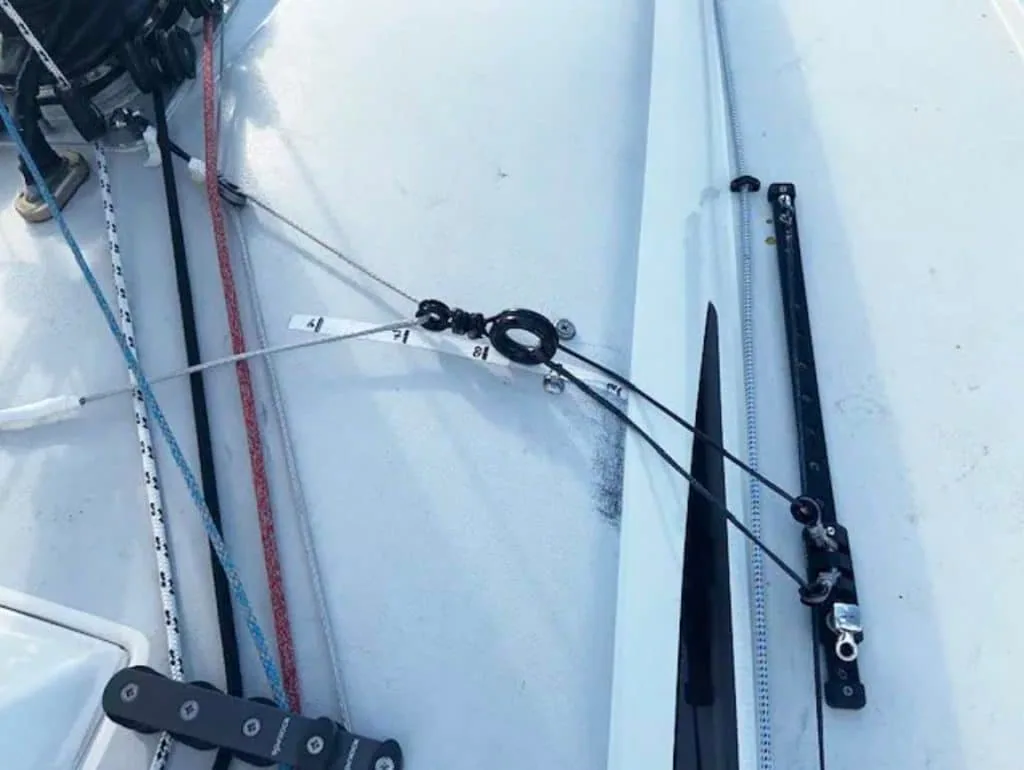 Close-up of an inboard genoa sheeting track and block mounted on a sailboat's cabin top