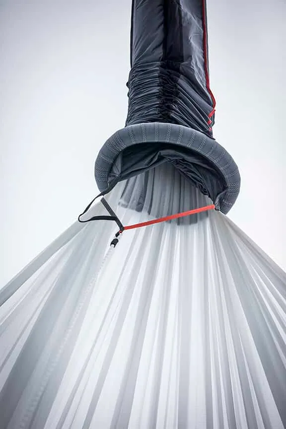 Close-up of a spinnaker gathered in an inflatable dousing sock at the head