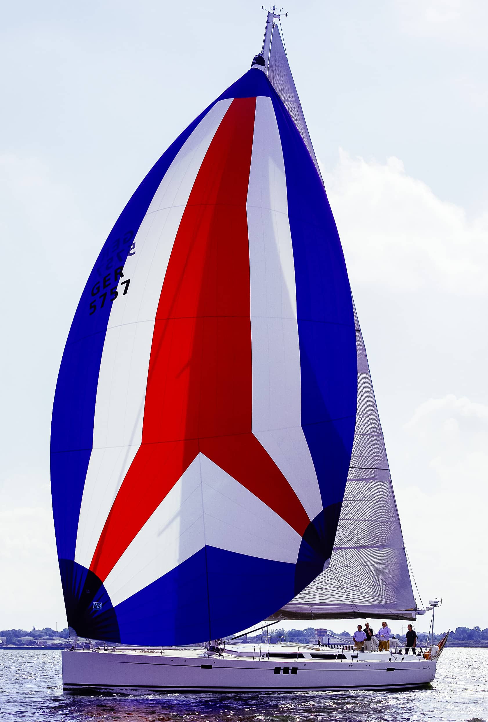 A cruising spinnaker set on a Hanse 630 — handled by two with a dousing sock.