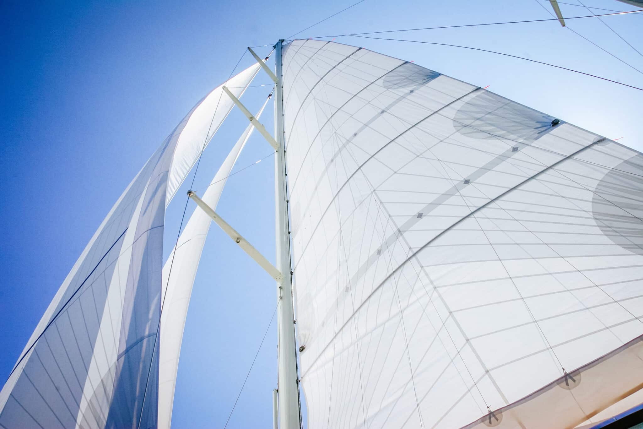 Looking up a mast at a tri-radial Spectra full-length-batten cruising mainsail beside the genoa