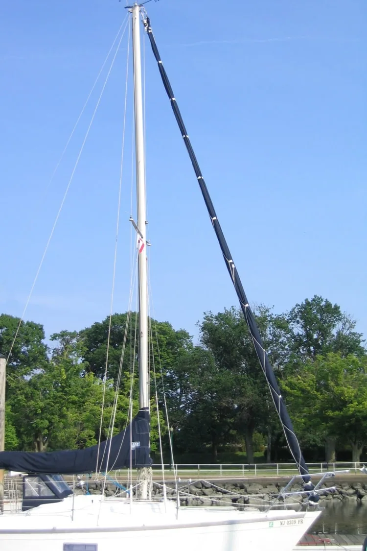 Long black jib sock running down a headstay from the masthead