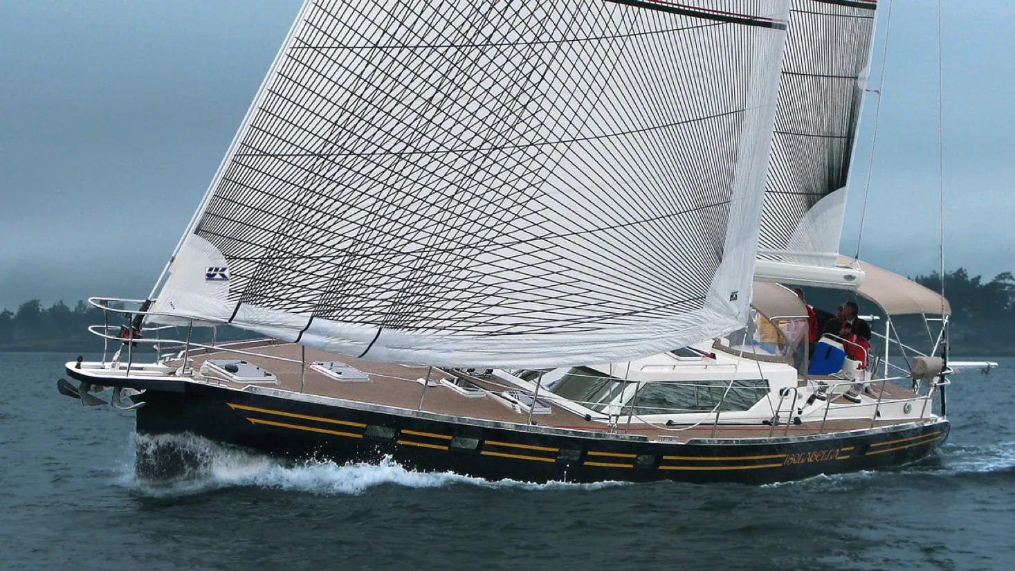 Cruising yacht broad reaching under full main and roller-furling Passagemaker genoa