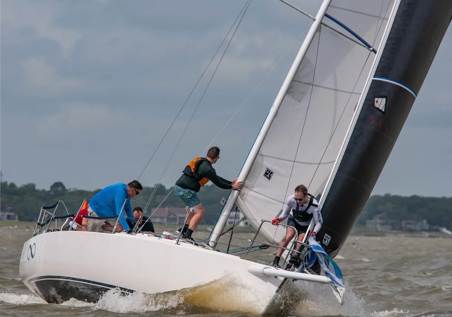 J/105 INFINITY heeled hard with crew scrambling as it sets its spinnaker