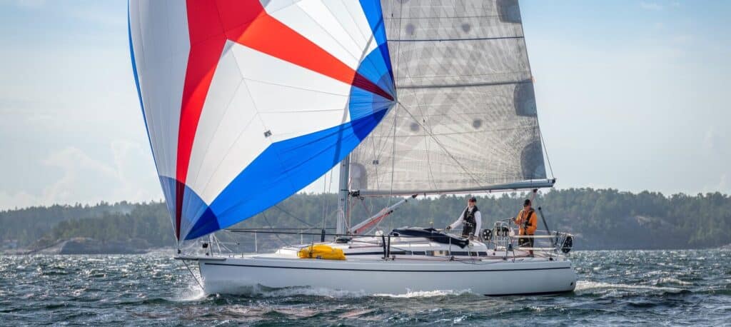 Arcona 380 doublehanded under a red, white and blue asymmetric
