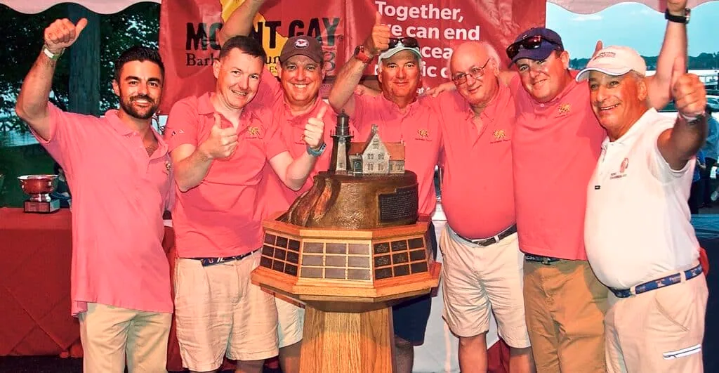 Team Christopher Dragon in pink shirts celebrating with the Northern Ocean Racing Trophy