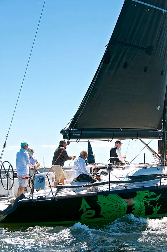 Christopher Dragon sailing upwind, her black hull with a green dragon graphic visible