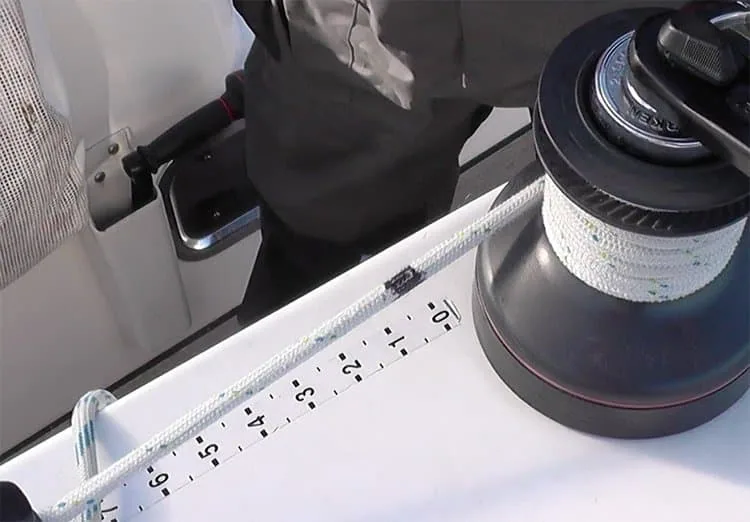 Halyard marked with a numbered measuring scale next to the mast winch