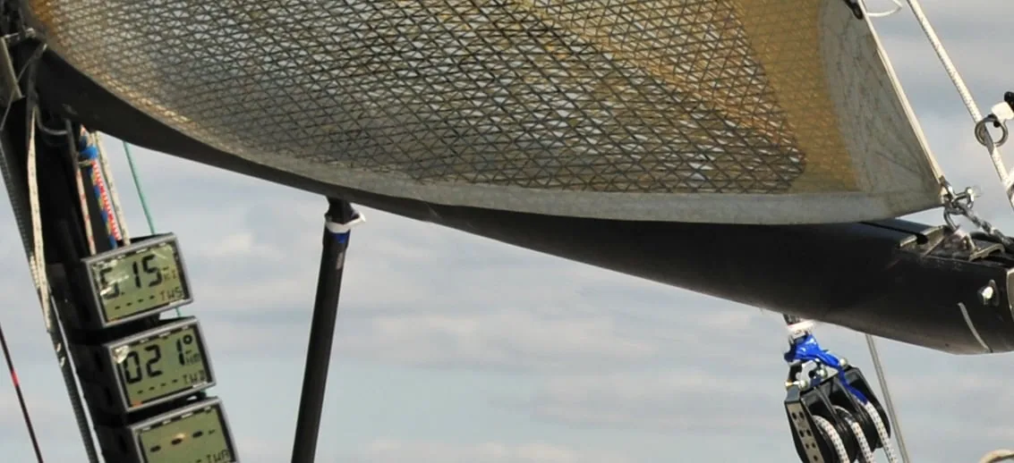 Close-up under the boom of a loose-footed mainsail's foot and clew