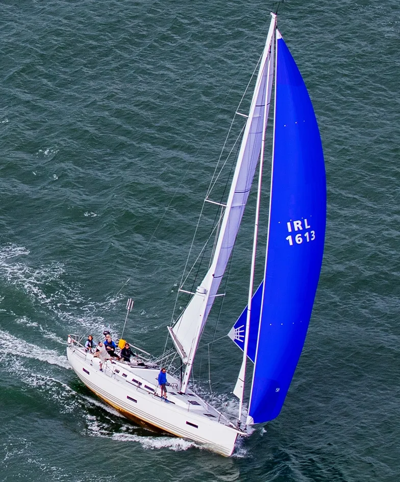 X4.3 cruiser reaching downwind under a deep-blue Easy Furl Code D spinnaker