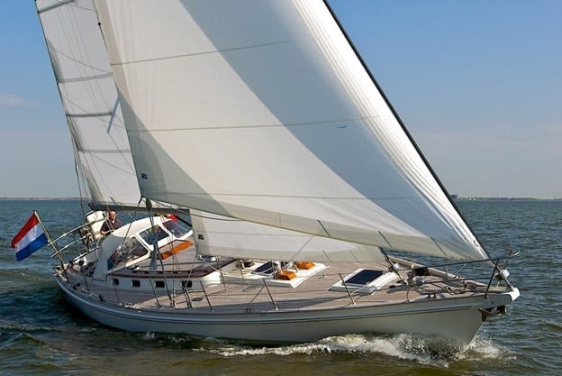 Cruising yacht under a cross-cut Dacron mainsail and genoa, Dutch flag flying