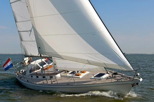 Cruising yacht under a cross-cut Dacron mainsail and genoa, Dutch flag flying