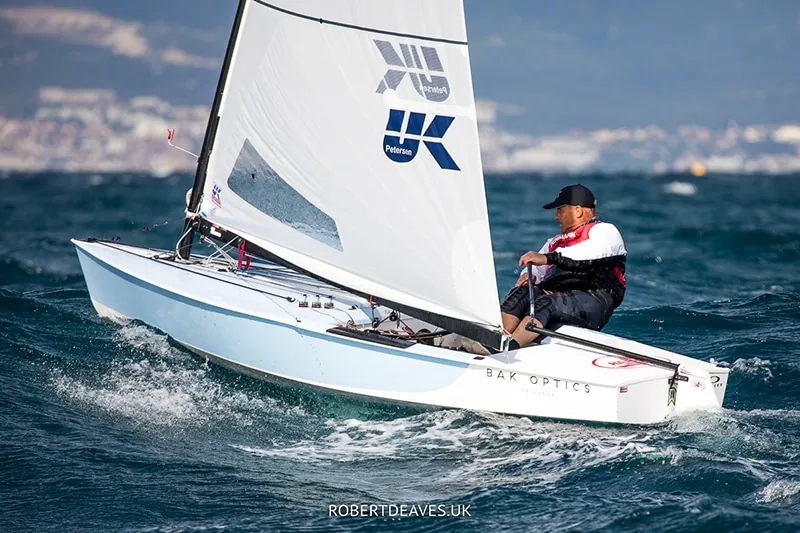 Bo Petersen sailing an OK Dinghy upwind under a UK Sailmakers sail