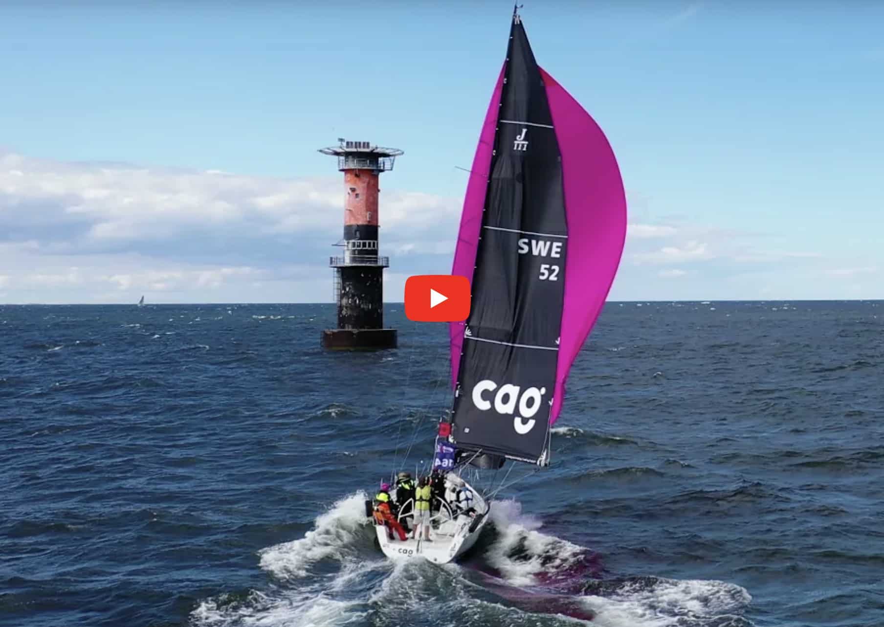 Video thumbnail: sailboat SWE 52 flying a pink spinnaker near a lighthouse, kite drop demo