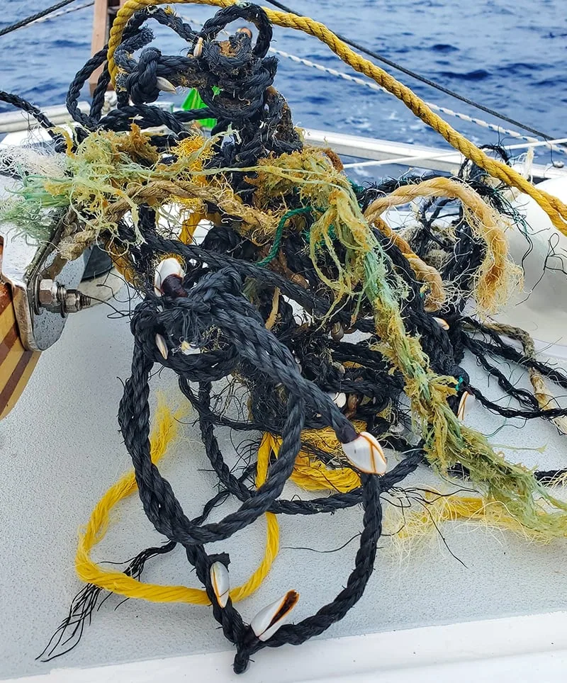 Tangled mass of derelict fishing net and rope pulled aboard a boat