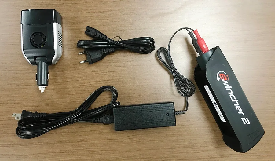 Ewincher 2 battery pack shown with its car, wall and mains charging cables