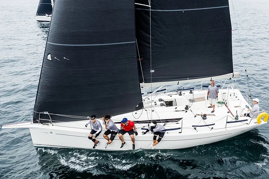 Aerial view of Italia 9.98 racing with crew hiking out to windward