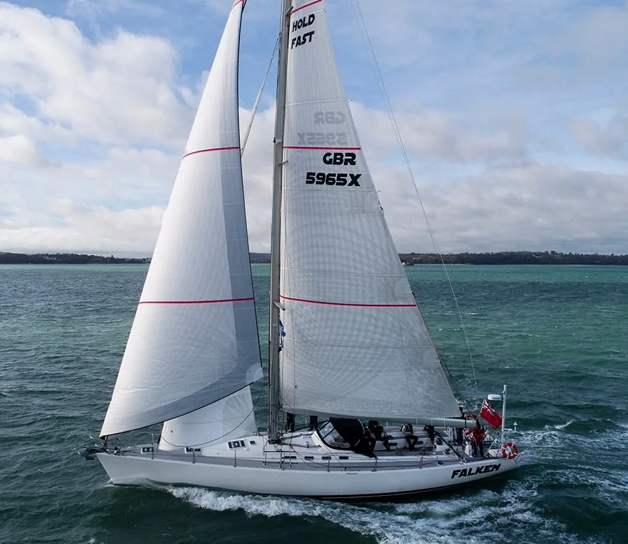 Farr 65 Falken heeled under sail, "Hold Fast" lettered on the mainsail