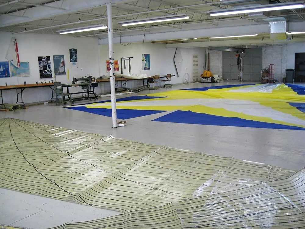 Blue, yellow and white spinnaker laid out across the UK Miami loft floor