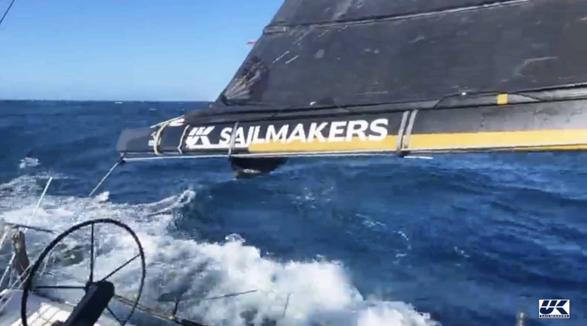 Boat heeled hard with its UK Sailmakers boom cover skimming the water