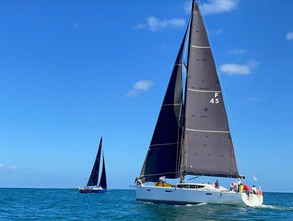 Sirene, sail F45, rounding first ahead of a rival under a dark mainsail