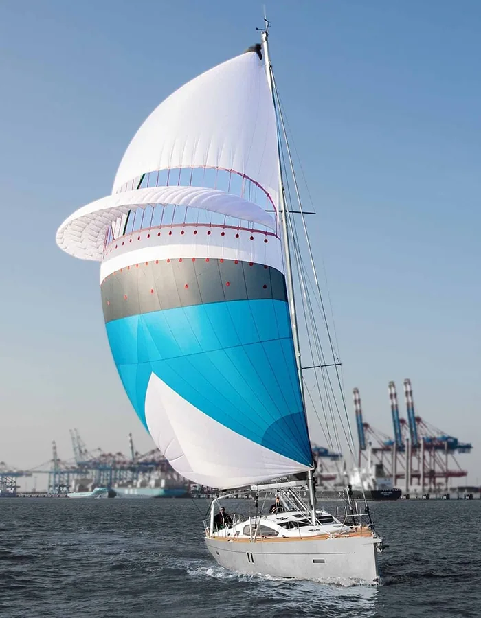 Blue, white and black striped asymmetric spinnaker filled aboard a cruising monohull