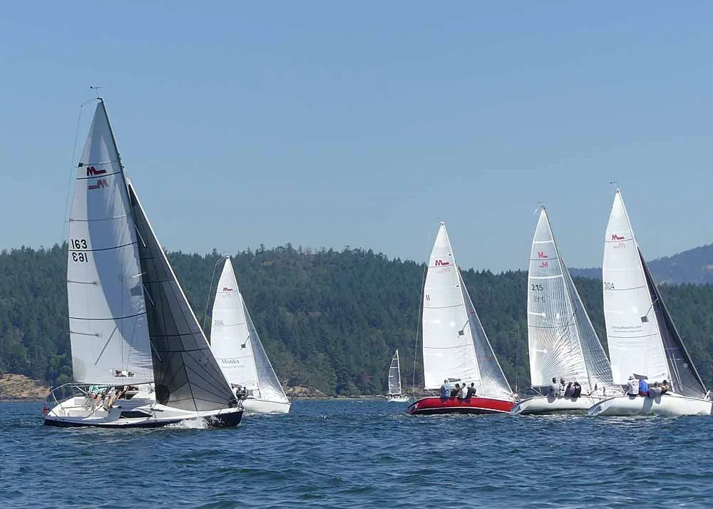 M242 fleet racing upwind in a tight pack at the 2022 Cow Bay Regatta