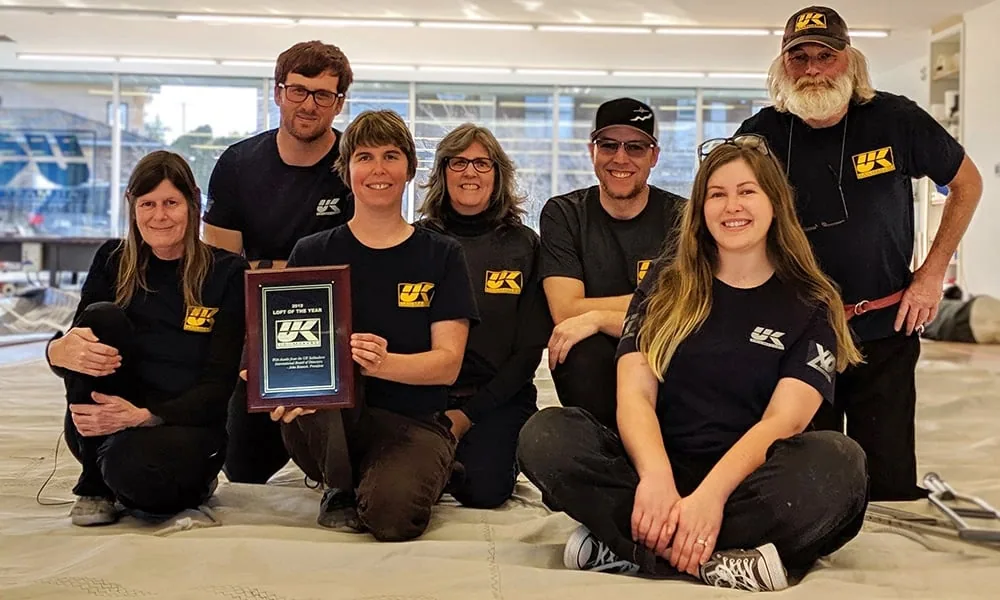 UK Sailmakers Northwest loft team holding their Loft of the Year award plaque