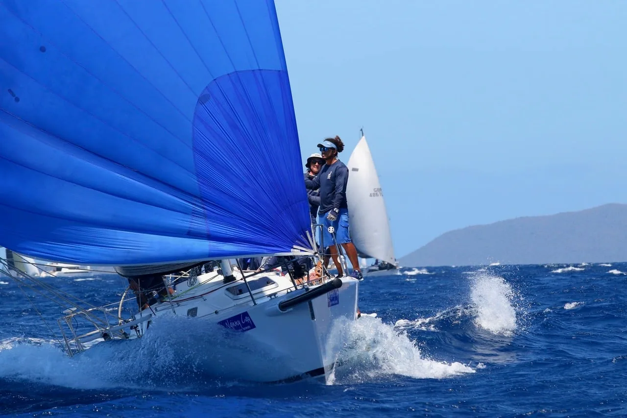 J/105 Jenk's blue asymmetric spinnaker fills as the crew trims from the rail