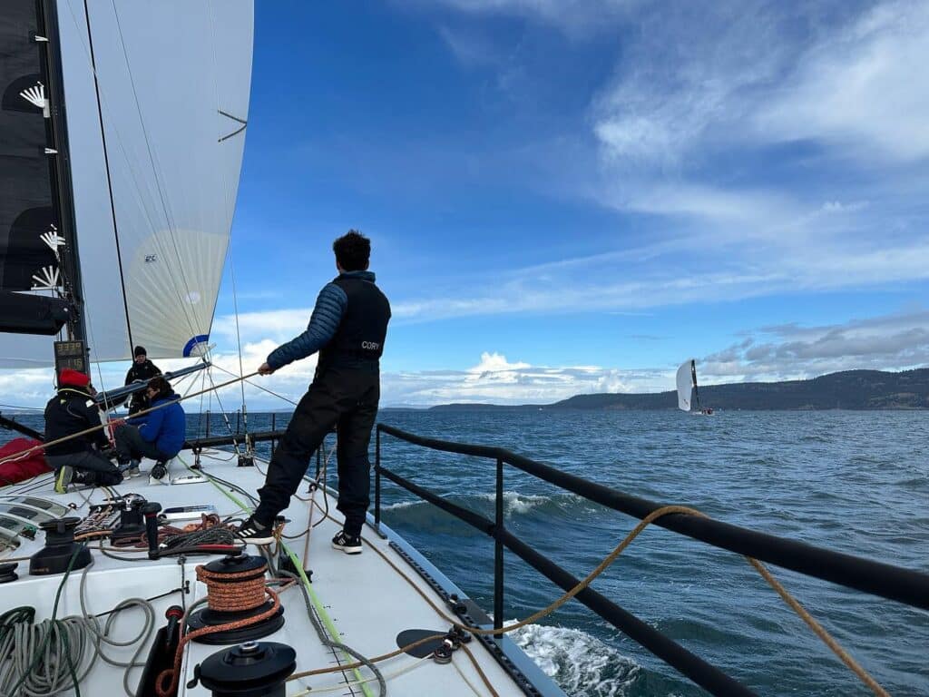 Cory Schillaci trims the spinnaker aboard Westerly during the Patos Island Race