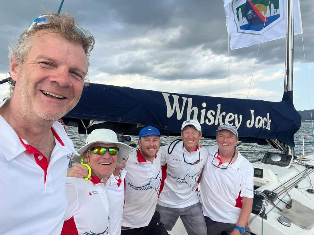 Whiskey Jack crew pose for a selfie beneath the boom after their China Sea Race win