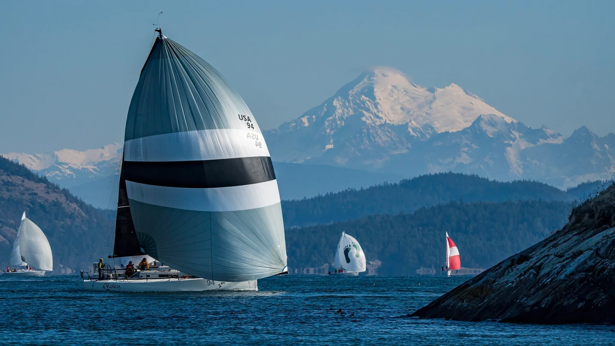 J/111 Raku sails downwind with snow-capped Mount Baker behind