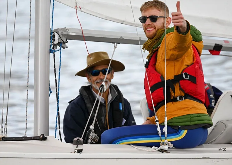 Adam Loory sails with Julian Klus, who gives a thumbs-up, at Robie Pierce