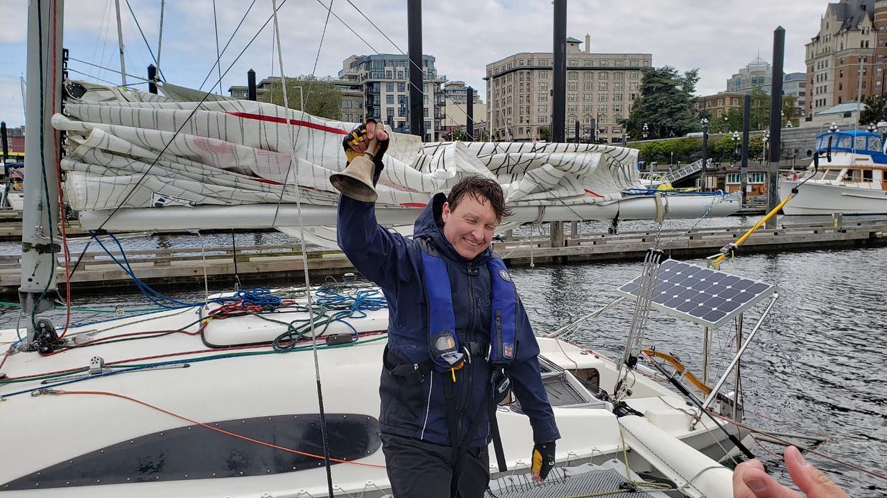 Eric Pesty raises the finish bell dockside after his solo R2AK speed record
