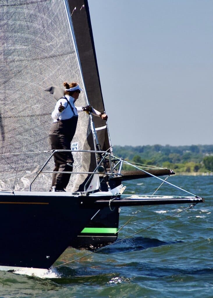 The bow of CHRISTOPHER DRAGON (green boot stripe) pokes out to leeward of ATALANTA in some exciting startline action.