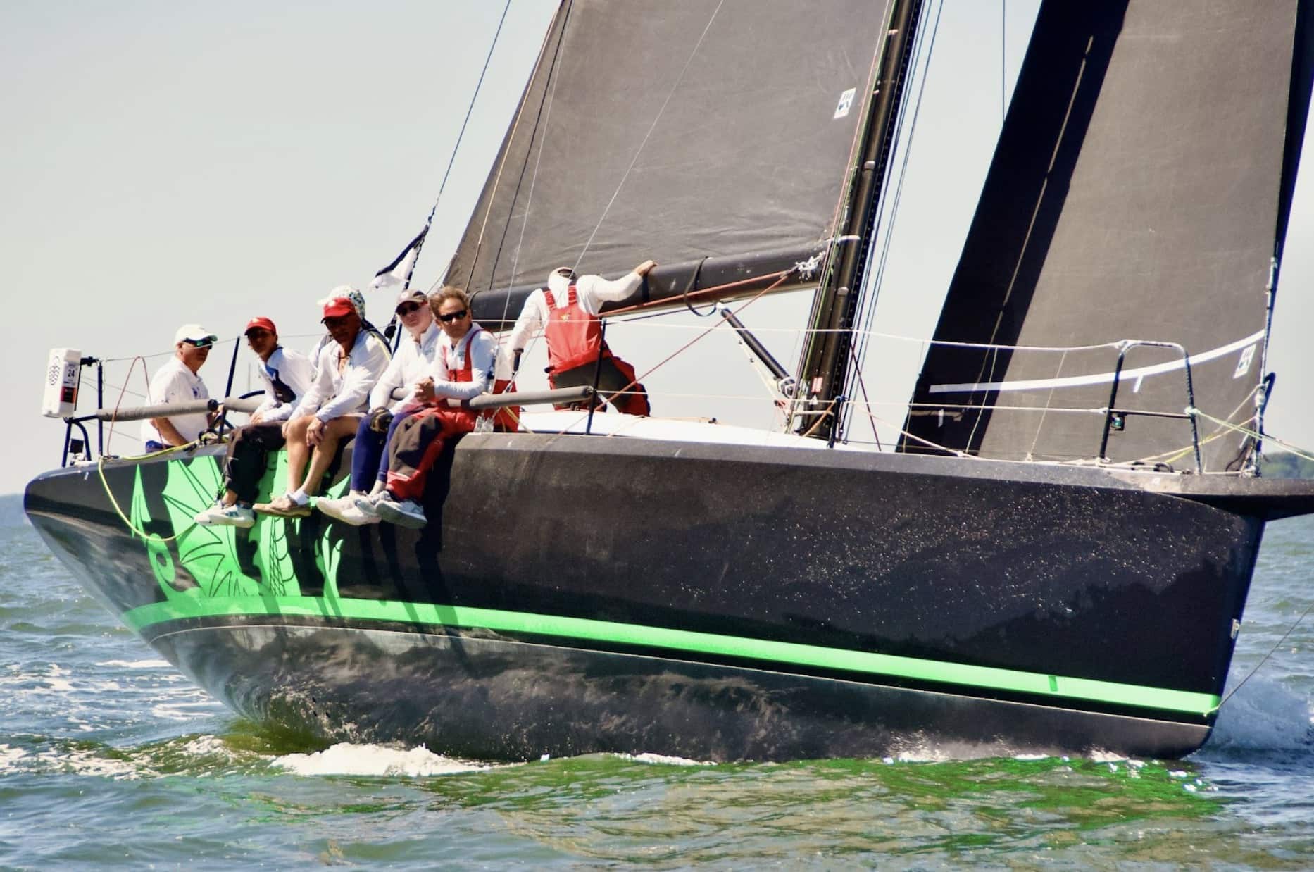 CHRISTOPHER DRAGON sailing upwind under black UK Sailmakers Titanium sails, crew hiking out