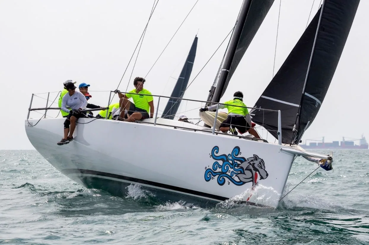 SEAWOLF 2, hull decorated with a blue wolf graphic, powers upwind at the Volvo China Coast Regatta