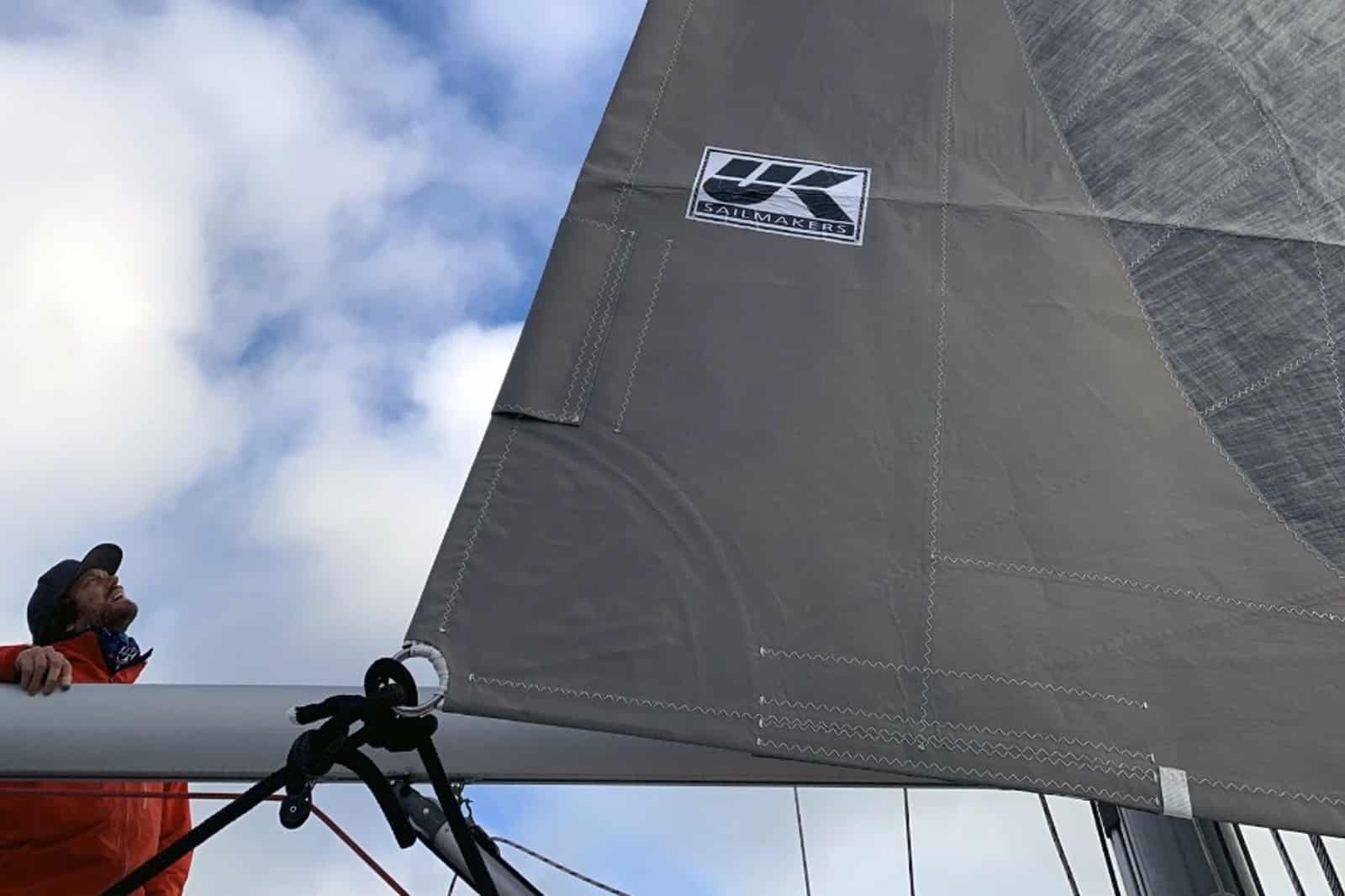 UK Sailmakers logo on a grey sail cover, viewed from the cockpit looking aloft