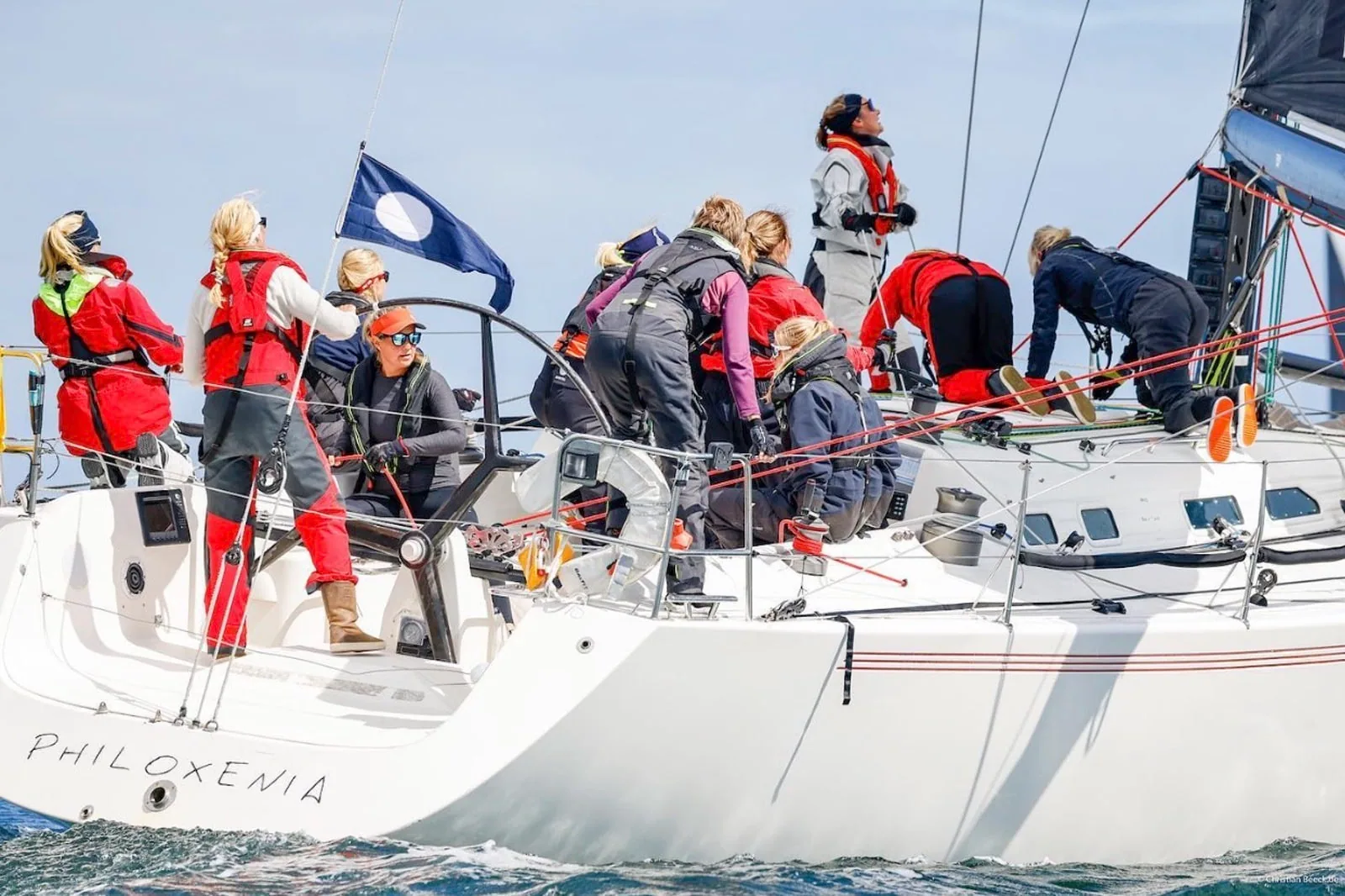 All-female crew in red foul-weather gear working the foredeck of PHILOXENIA