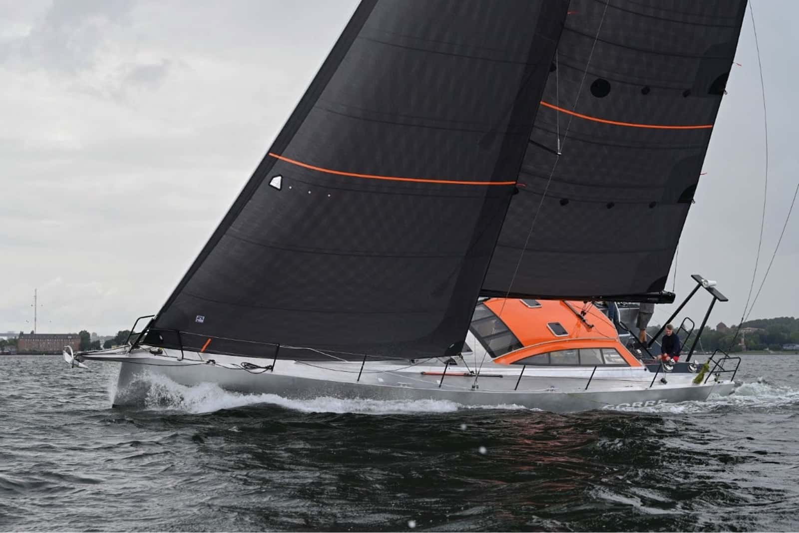 Berckemeyer BM49 sailing under black X-Drive® Carbon upwind sails, orange cockpit visible
