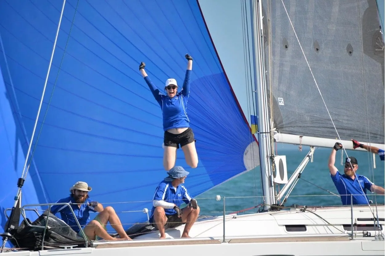 Foredeck crew Victoria Willetts jumps for joy as MINKE crosses the finish line first