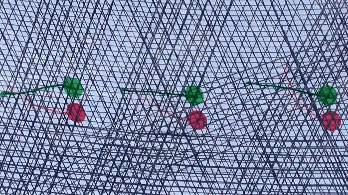Close-up through crossed rigging lines with green and red sighting marks for trim reference