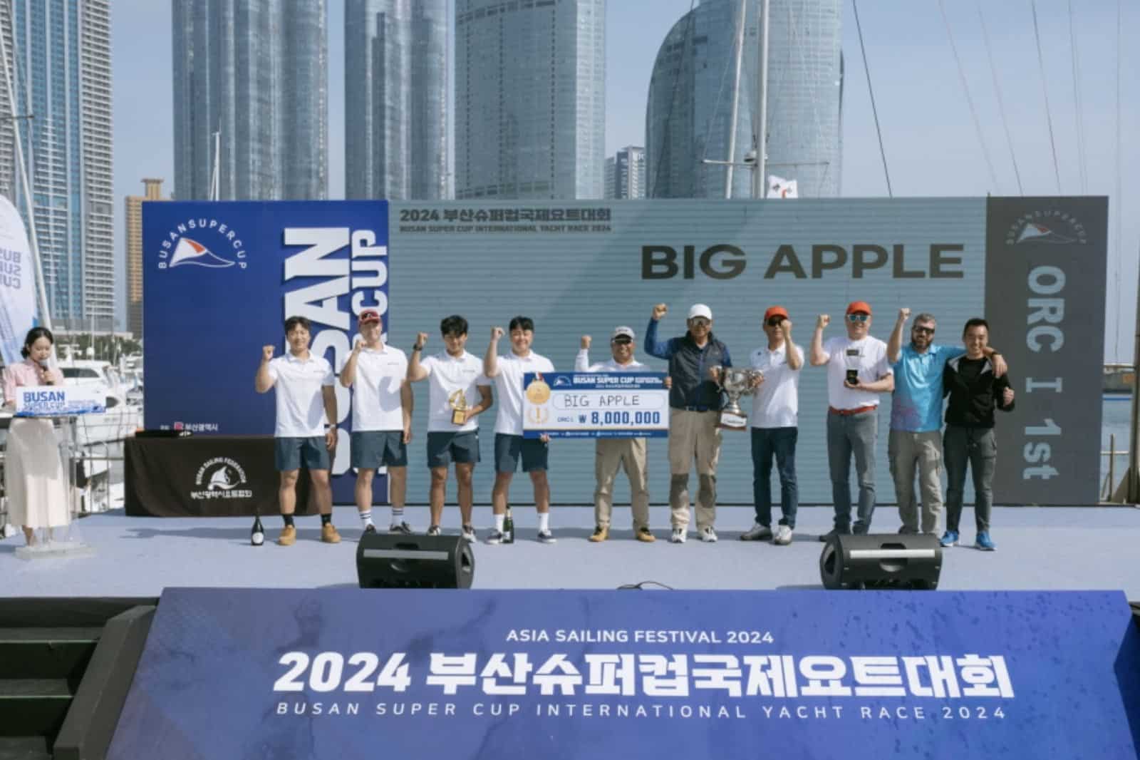 BIG APPLE III crew celebrating on stage at the Busan Super Cup awards ceremony