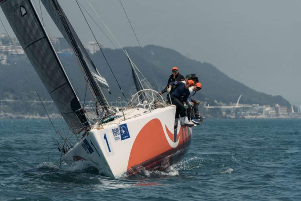 BIG APPLE III reaching hard under black sails along the Korean coastline