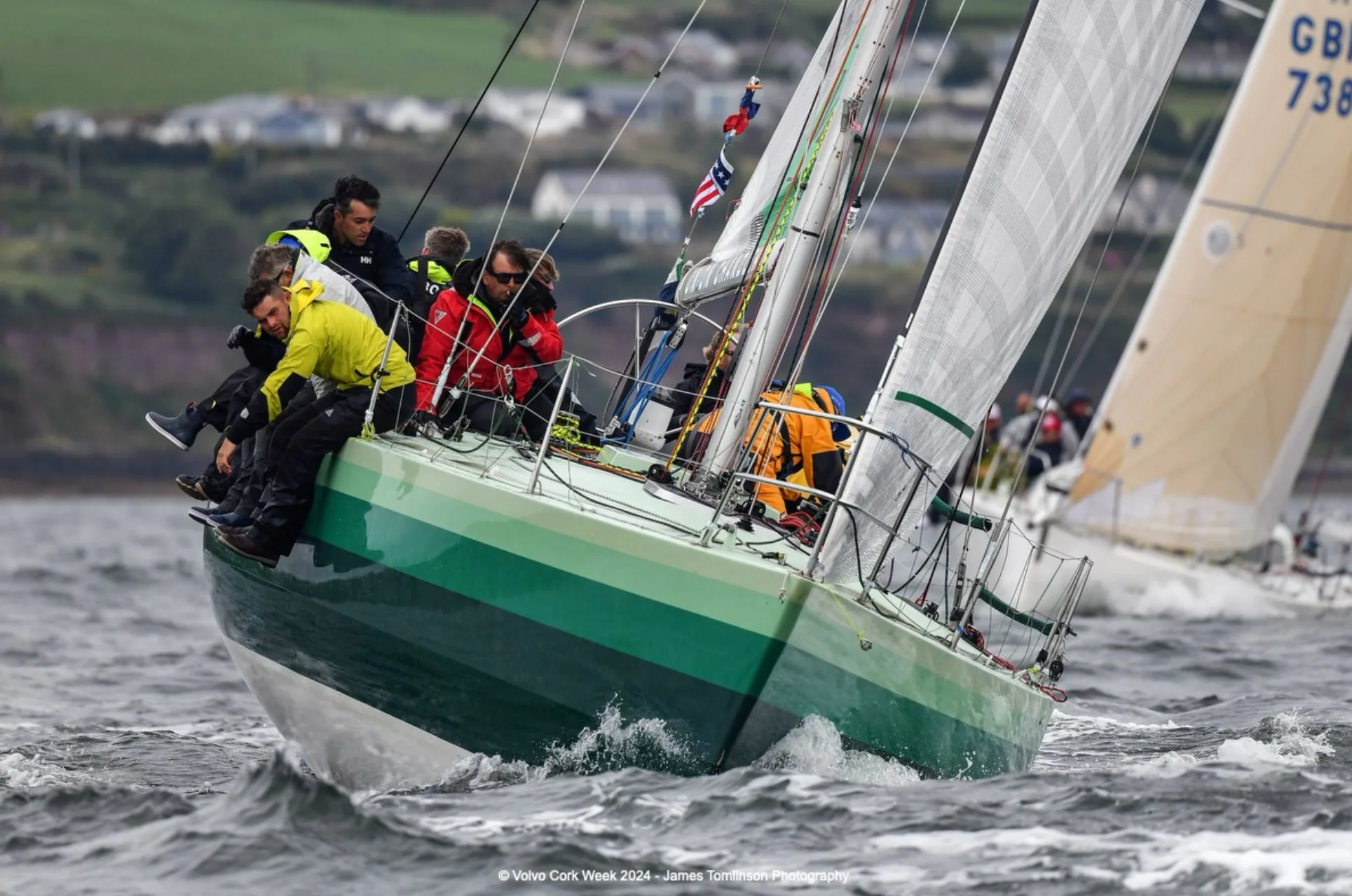 Holland 39 IMP hiking hard with a green hull heeled over at Volvo Cork Week