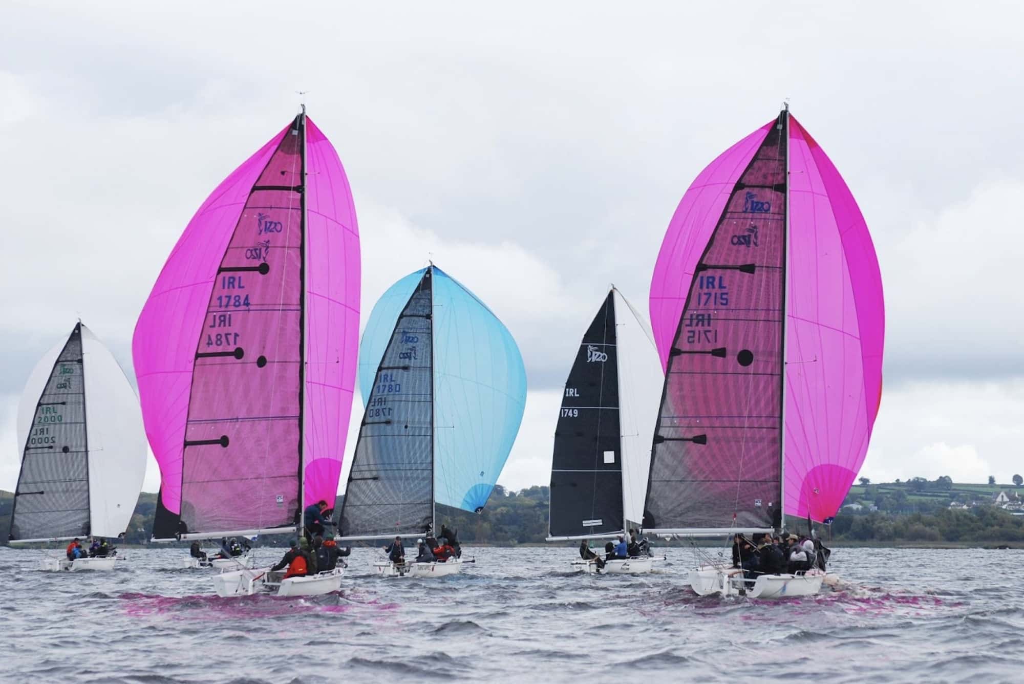 ROPE DOCK ATARA leads a fleet of 1720 Sportsboats under pink and blue spinnakers.