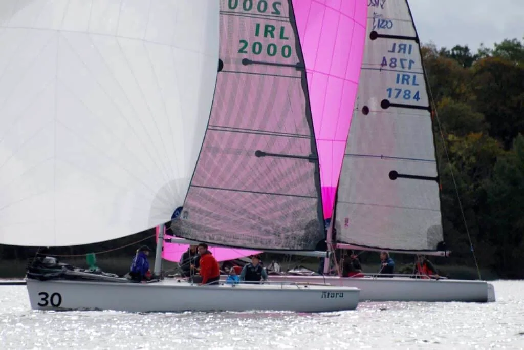 1720 Sportsboats IRL 2000 and IRL 1784 race close together under a pink spinnaker.