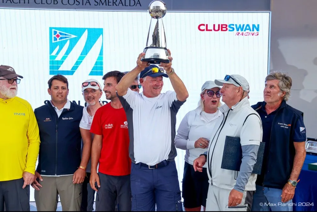 KATIMA's skipper lifts the trophy on stage at the Rolex Swan Cup prize-giving.