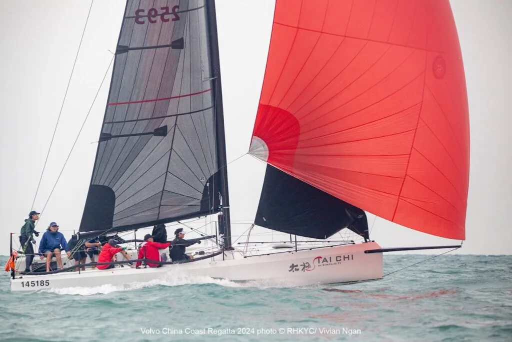 TAI CHI sails under a red spinnaker and grey headsail numbered 2593.