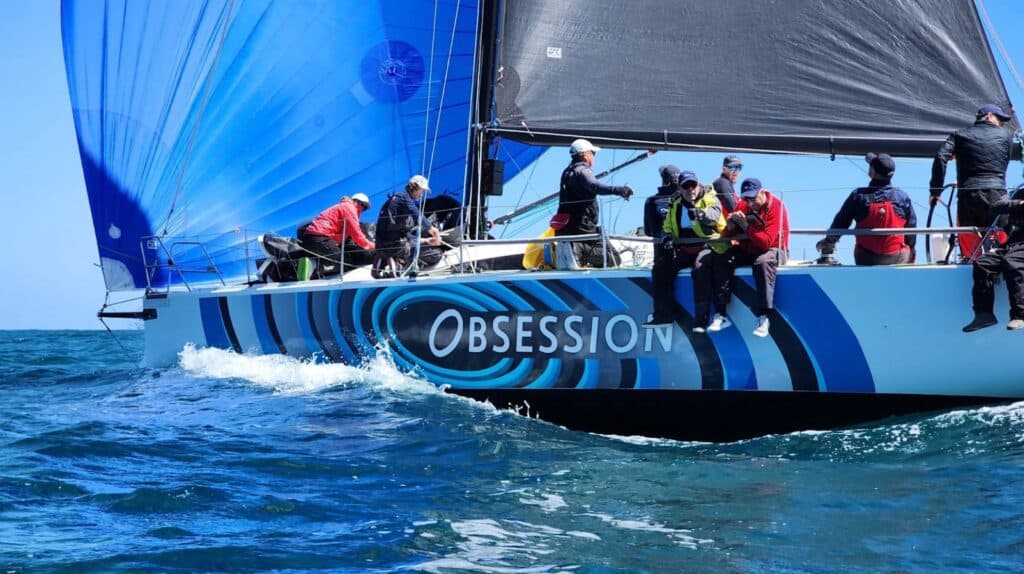 OBSESSION reaches under a blue spinnaker and Titanium mainsail from UK Sailmakers Fremantle.